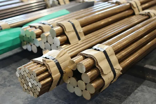 Bundled and strapped bronze bars stacked in storage