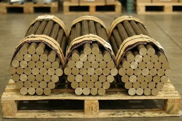 Strapped bundles of bronze rods on a pallet